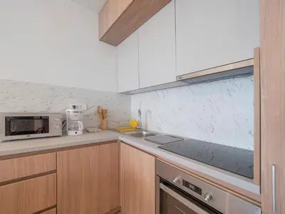 a kitchen with a sink and a microwave at Horizon-One bedroom apartment with pool Jane in Becici