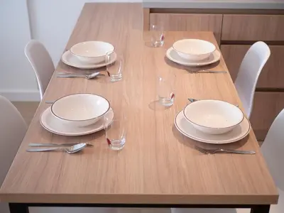 a wooden table with plates and silverware on it at Horizon-One bedroom apartment with pool Jane in Becici