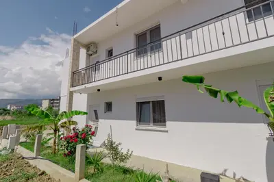 a white building with flowers in front of it at Medo in Ulcinj