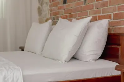 a group of white pillows sitting on a bed at Medo in Ulcinj