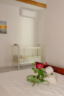 a white crib in a room with a crib at Medo in Ulcinj