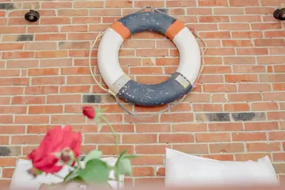 a wreath is hanging on a brick wall with flowers at Medo in Ulcinj