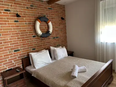 a bed in a room with a brick wall at Medo in Ulcinj