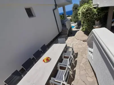 a bench with chairs and a plate of food on it at Villa Dedin in Utjeha