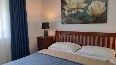 a bedroom with a bed and a painting on the wall at Villa Dedin in Utjeha