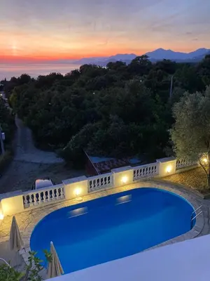 a swimming pool in a villa at sunset at Villa Dedin in Utjeha