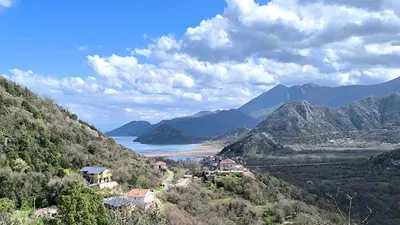 a view of a valley with a lake and mountains at Liprosh in Virpazar
