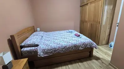 a small bedroom with a bed and a wooden cabinet at Liprosh in Virpazar