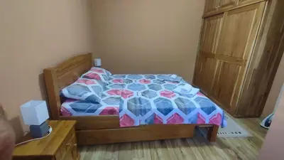a bedroom with a bed with a colorful comforter at Liprosh in Virpazar