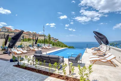 a villa with a pool and a view at Quercus Residences Apartments in Sveti Stefan