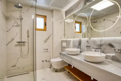 a bathroom with two sinks and a shower at Quercus Residences Apartments in Sveti Stefan