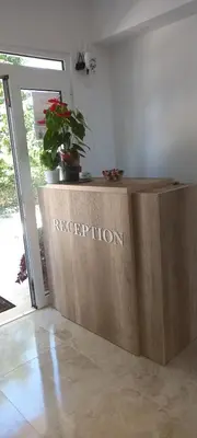 a reception desk in a room with a reputation sign on it at Apartments kupi ul rudaj 41 in Ulcinj