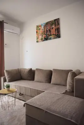 a living room with a couch and a painting on the wall at Apartments kupi ul rudaj 41 in Ulcinj