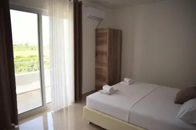 a bedroom with a bed and a large window at Apartments kupi ul rudaj 41 in Ulcinj