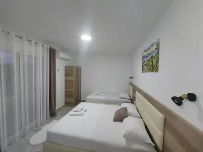 a white room with a bed and a window at Apartments kupi ul rudaj 41 in Ulcinj