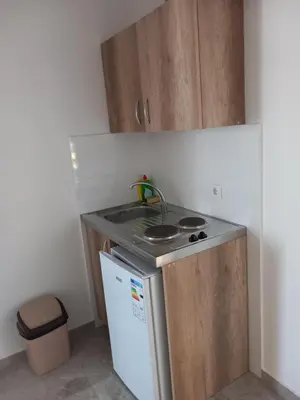 a small kitchen with a sink and a refrigerator at Apartments kupi ul rudaj 41 in Ulcinj