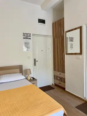 a bedroom with a bed and a door to a closet at Apartment Center in Sutomore