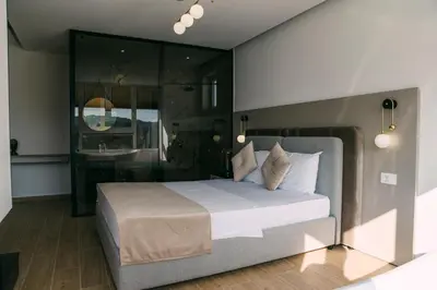 a bedroom with a large bed and a bathroom at Apartments Casa Mia in Ulcinj