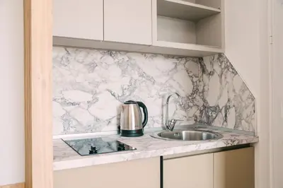 a kitchen with a marble counter top and a sink at Apartments Casa Mia in Ulcinj