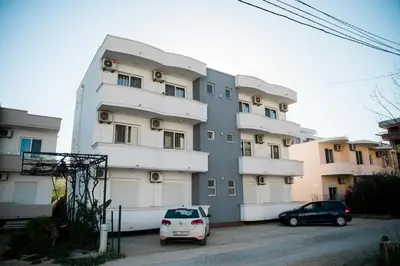 two cars parked in front of a building at Apartments Casa Mia in Ulcinj