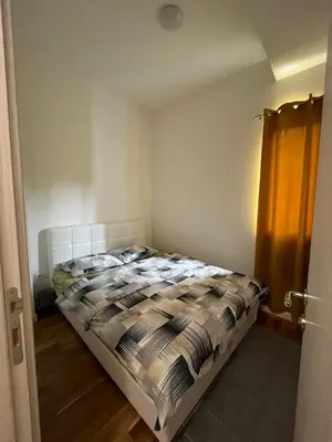 a bedroom with a bed in a small room at Apartment DORA in Cetinje