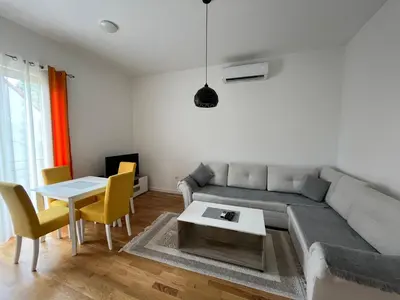 a living room with a couch and a table at Apartment DORA in Cetinje