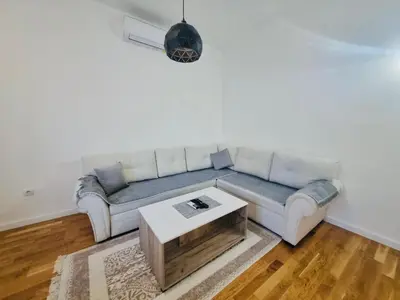 a living room with a couch and a coffee table at Apartment DORA in Cetinje
