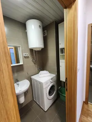 a bathroom with a washing machine and a sink at City life in Podgorica