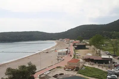a view of a beach with cars parked on it at Beachfront Hotel Palma - Jaz in Budva