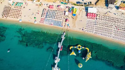 an aerial view of a beach and a boat in the water at Beachfront Hotel Palma - Jaz in Budva