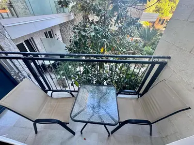 a bench on a balcony with a plant at Beachfront Hotel Palma - Jaz in Budva