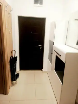 a black door in a kitchen with a white tile floor at Maša Bečići Apartman in Budva