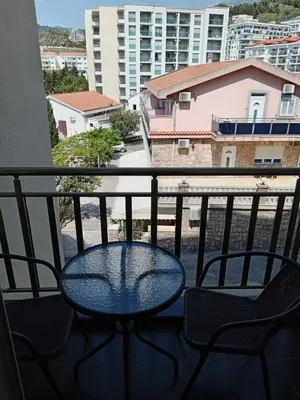 a table and chairs on a balcony with a view at Maša Bečići Apartman in Budva