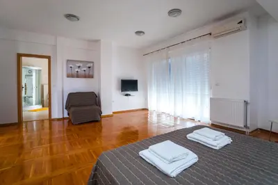 a room with a bed with two towels on it at Royal Villas in Dobra Voda