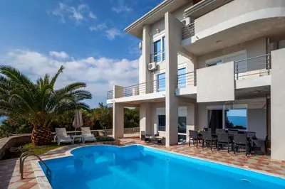 a villa with a swimming pool and a house at Royal Villas in Dobra Voda
