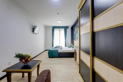 a hallway with a bed and a table in a room at Porta Volta Residence in Becici