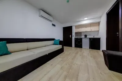 a living room with a couch and a kitchen at Porta Volta Residence in Becici