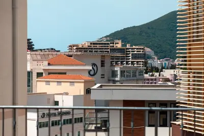 a view of a city with buildings and a mountain at Porta Volta Residence in Becici
