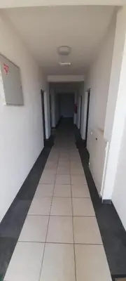 an empty hallway of a room with white walls and white floors at Apartment Luka in Podgorica