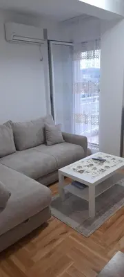 a living room with a couch and a coffee table at Apartment Luka in Podgorica