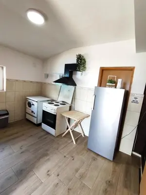 a kitchen with a refrigerator and a table in it at Vukićević House in Kotor