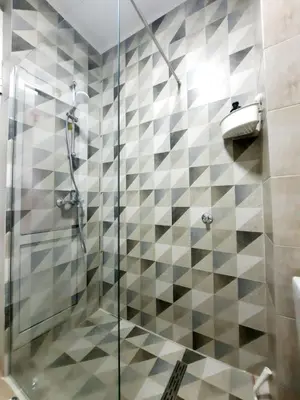 a bathroom with a shower with a glass door at Acacia apartmani Sutomore in Sutomore