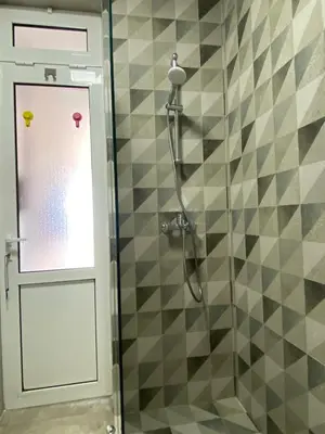 a shower with a glass door in a bathroom at Acacia apartmani Sutomore in Sutomore