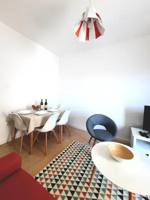 a living room with a dining room table and chairs at Acacia apartmani Sutomore in Sutomore