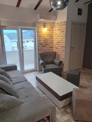 a living room with a couch and a chair at Budva stan Natasa in Budva
