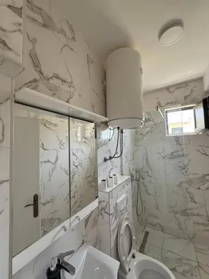 a bathroom with a toilet and a sink at Xhan Apartments in Ulcinj