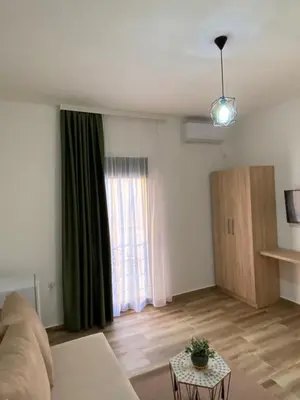 a living room with a couch and a window at Xhan Apartments in Ulcinj