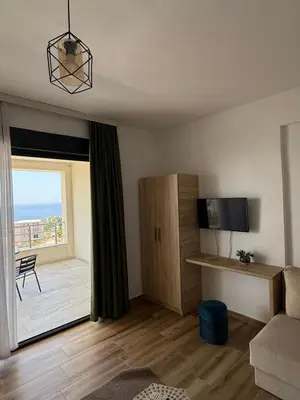 a living room with a room with a large window at Xhan Apartments in Ulcinj