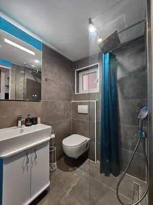 a bathroom with a toilet and a sink and a shower at Lolo Luxury rooms & suites in Budva