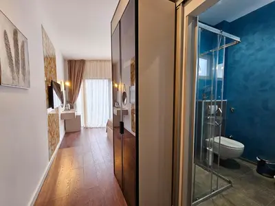 a bathroom with a toilet and a glass shower at Lolo Luxury rooms & suites in Budva